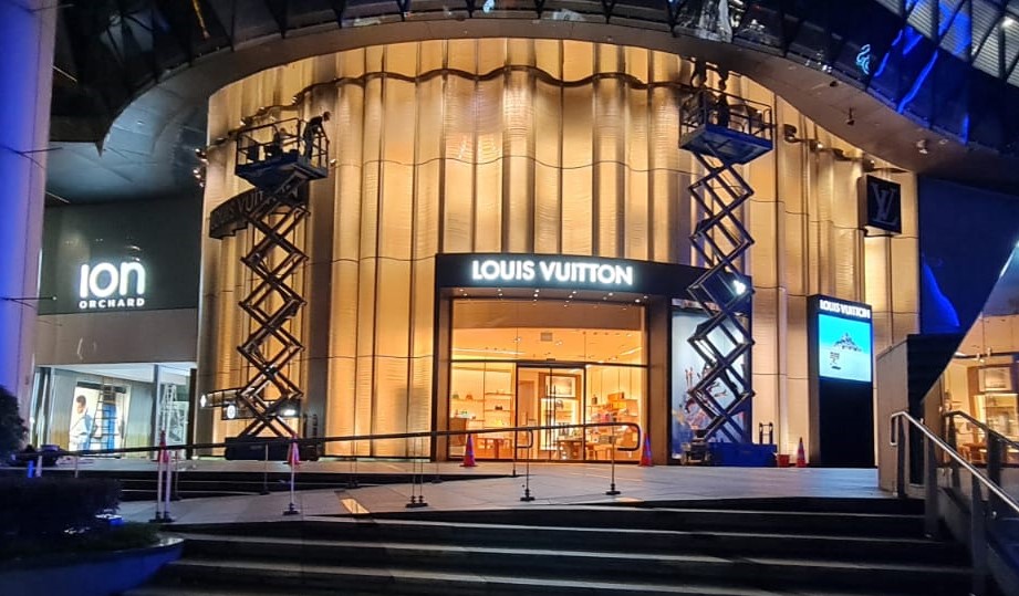 Professional cleaners cleaning the building facade of ION Orchard