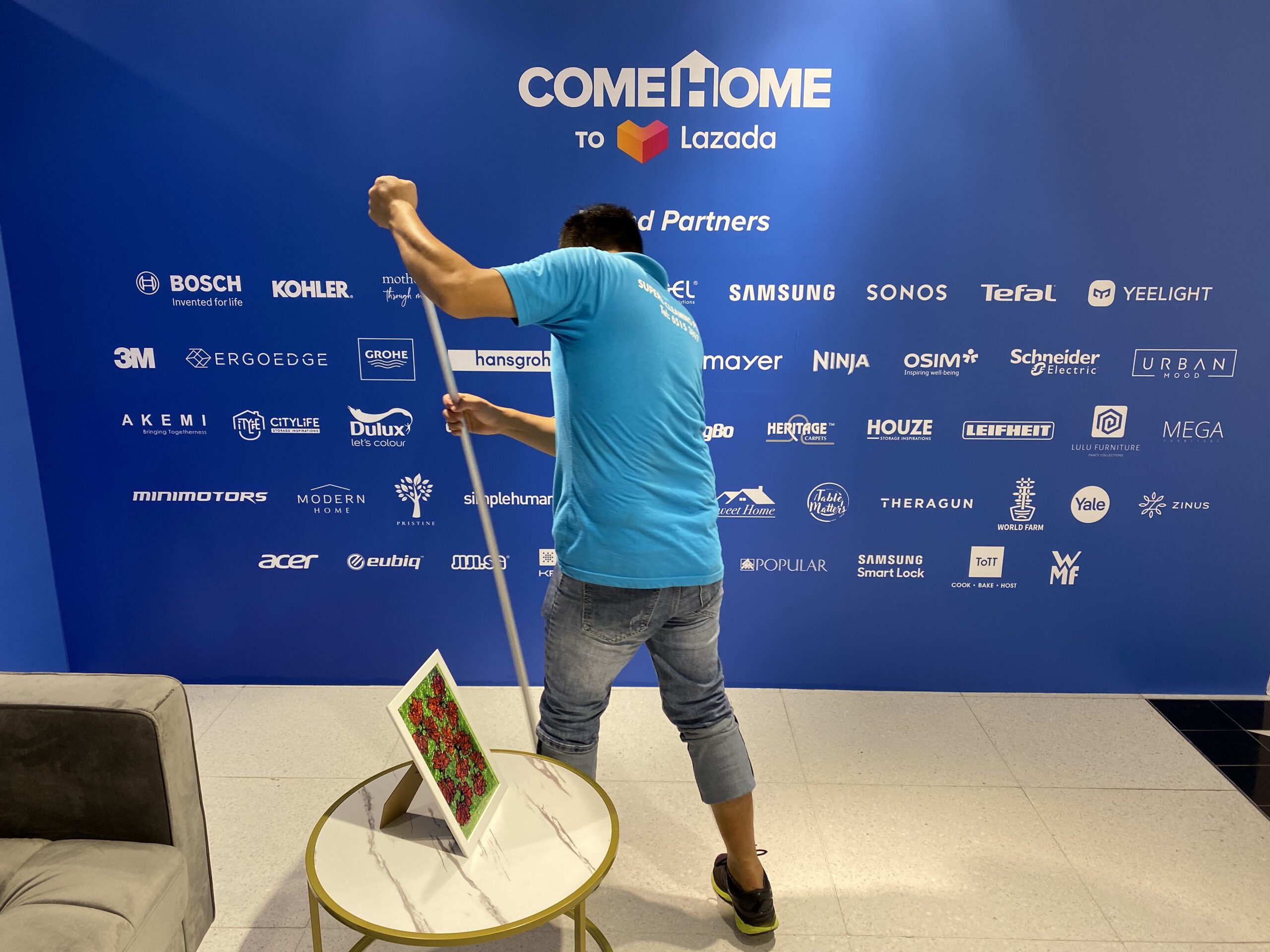 A professional cleaner cleaning the floor at the COMEHOME event