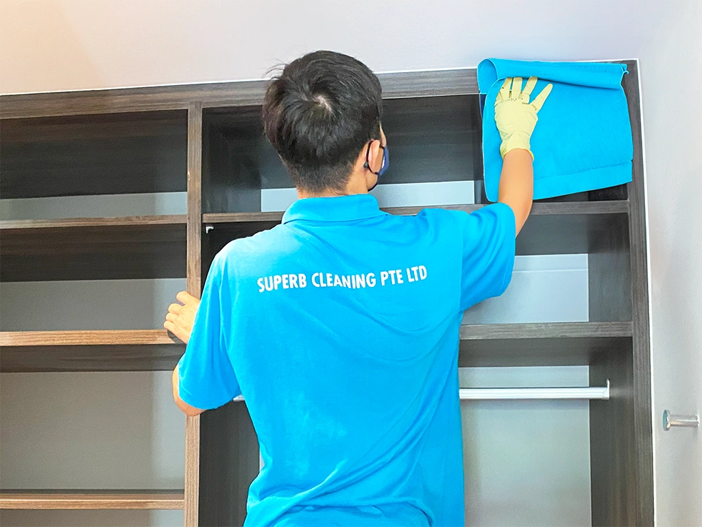 Superb Cleaning staff cleaning a cabinet